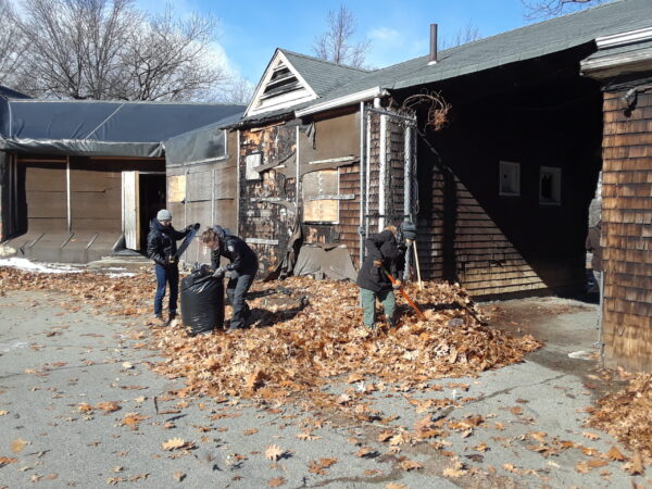SCA crew members raking leaves at the Speedway