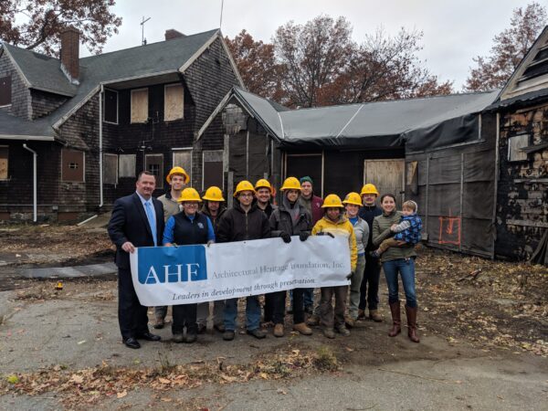 State Representative Michael Moran stands with AHF staff and the SCA crew holding an AHF banner in the Speedway courtyard.
