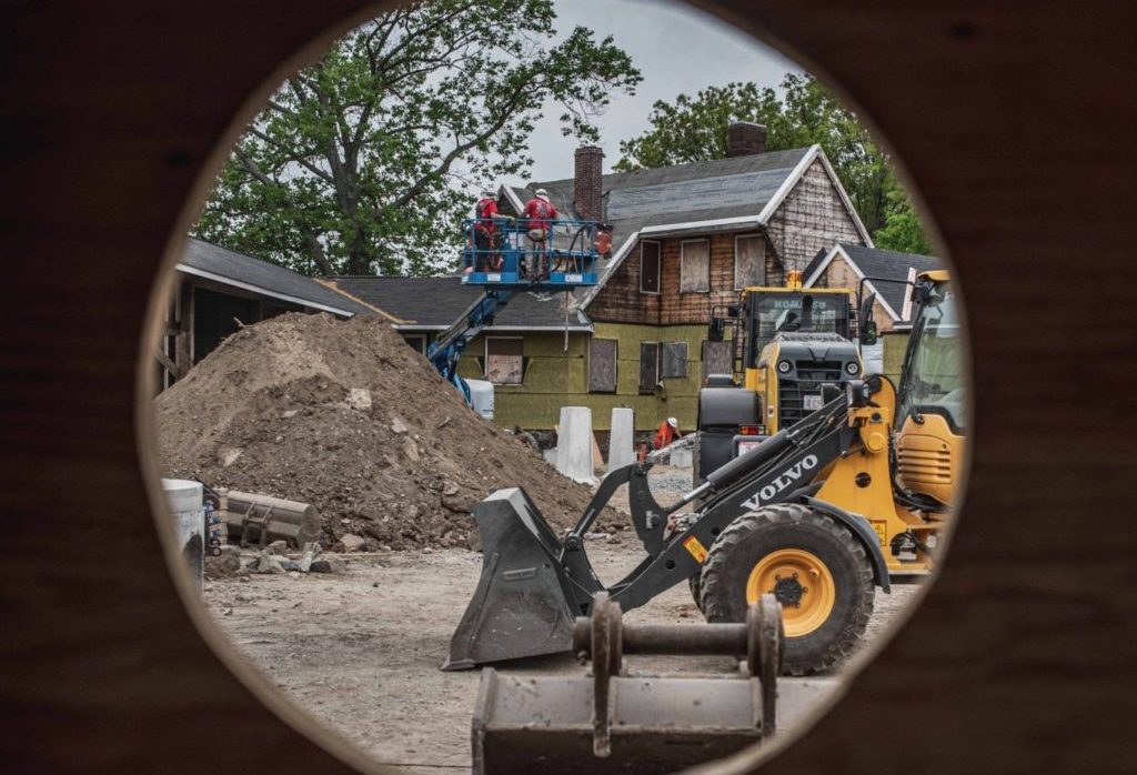 The Speedway courtyard construction site viewed through a hole in the interior wall